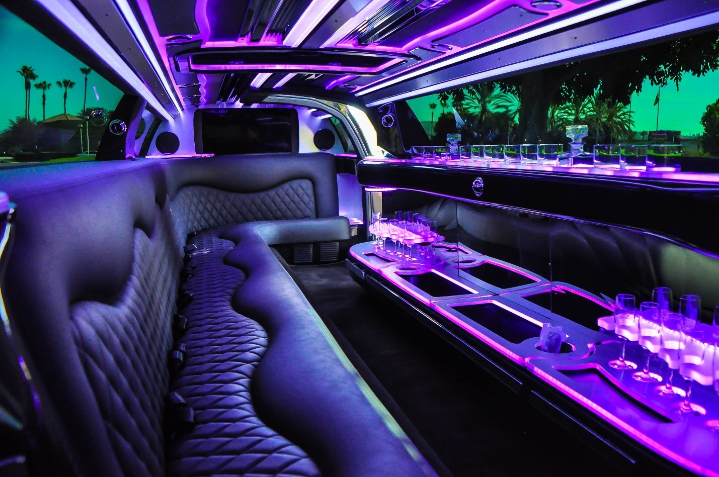 Group of friends stepping out of a concert limo service outside a Seattle venue at night